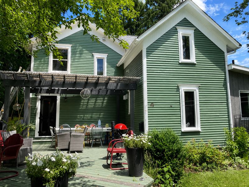 Residential exterior painting on an Ottawa home with green siding