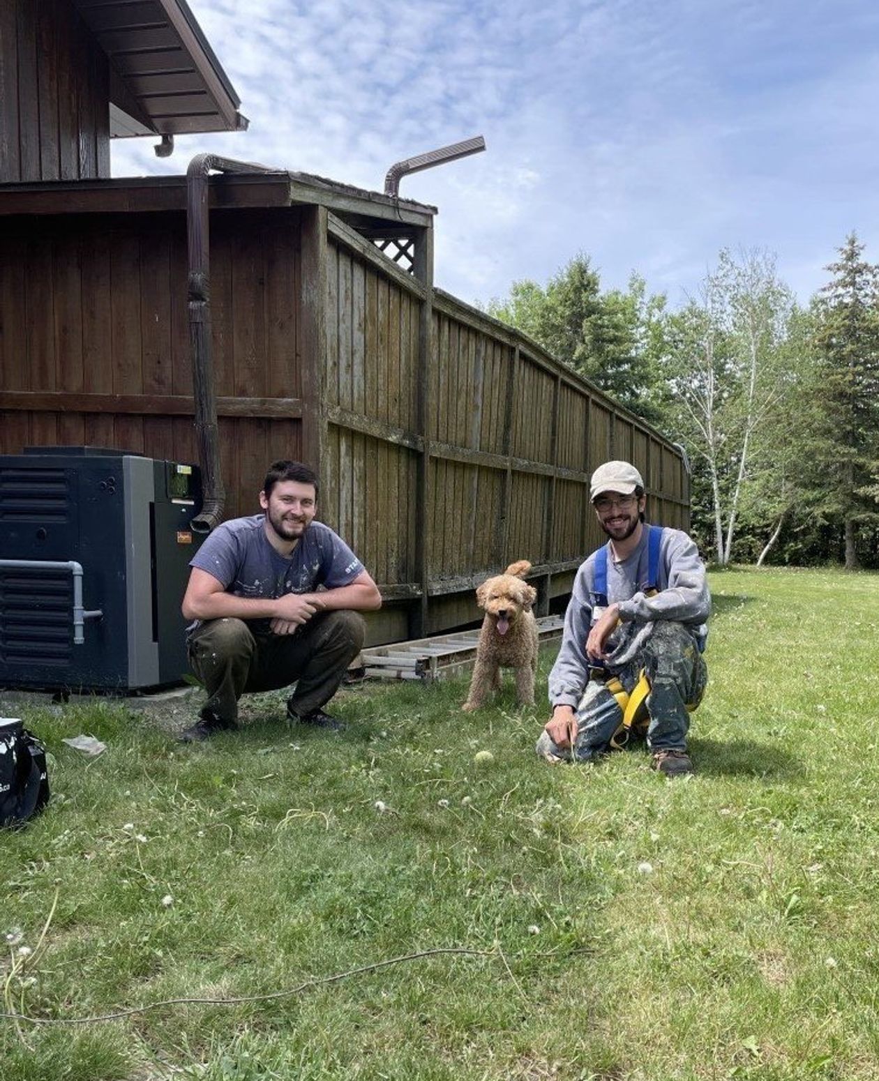 Owners, Matt and Will posing with client's dog
