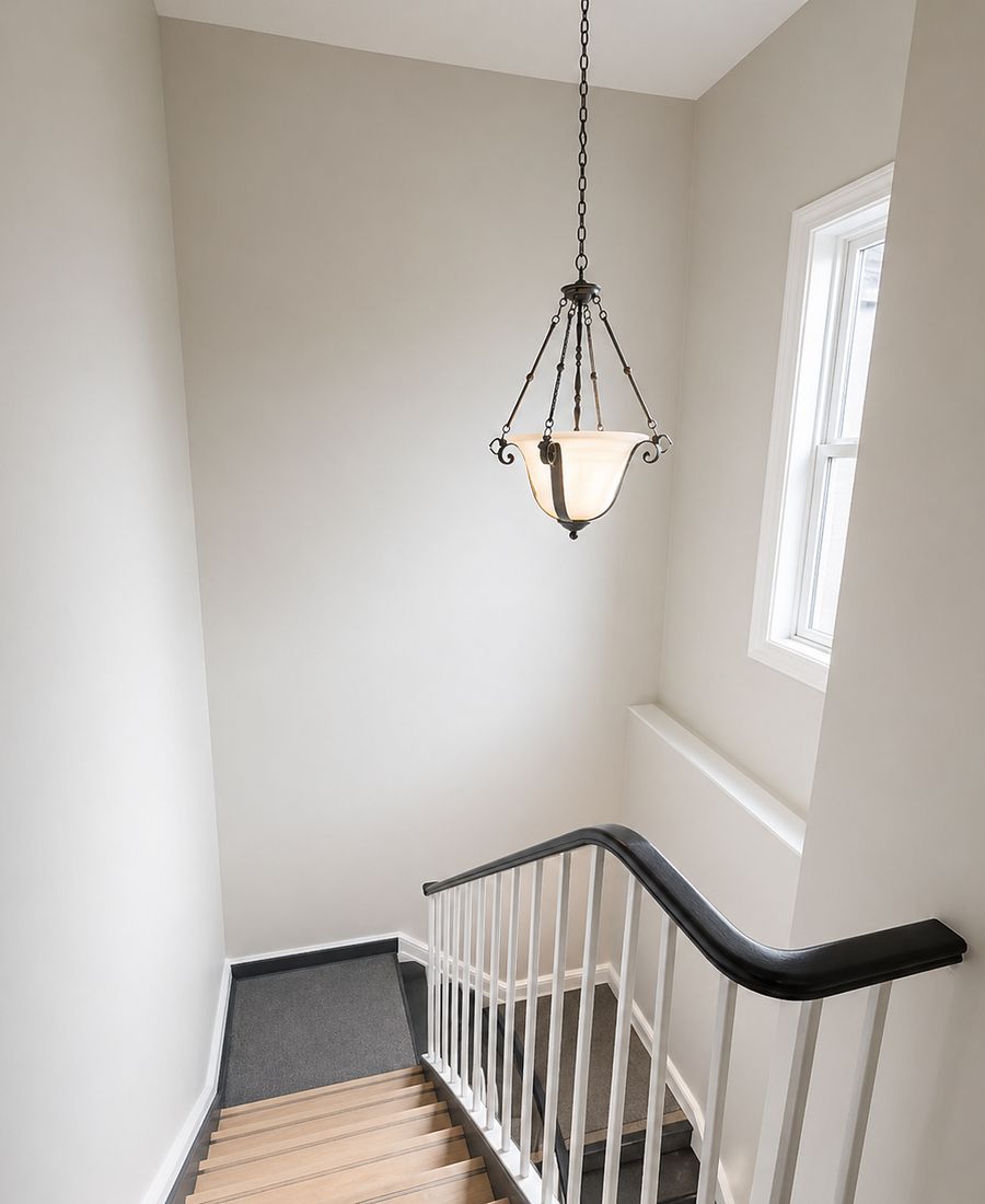 Repainted stairwell with neutral walls, crisp white trim, and refreshed spindles in Nepean