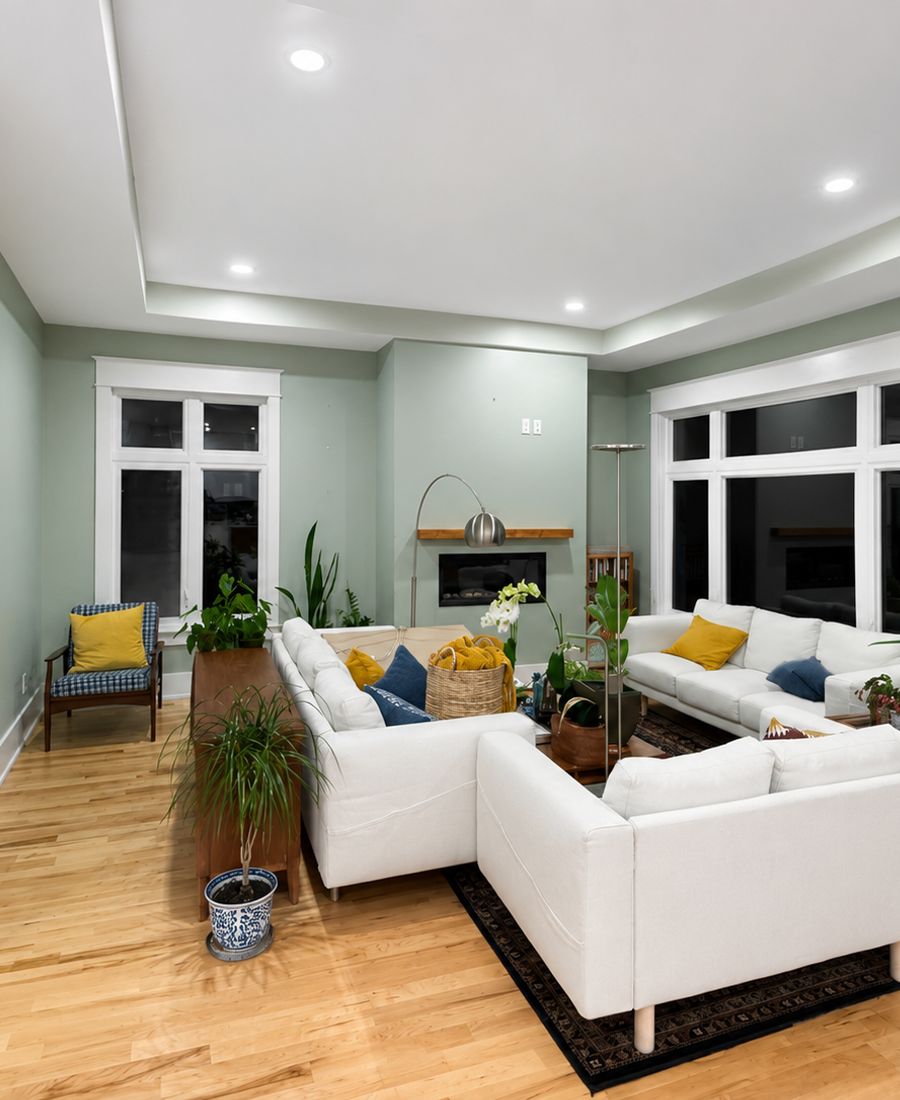 Living room with sage green accent wall, white trim, and warm neutral surroundings in Stittsville