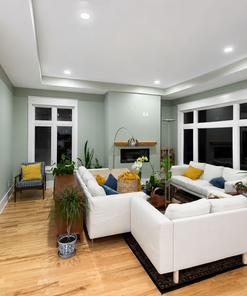 Ottawa living room painted in soft sage green with crisp white trim and tray ceiling