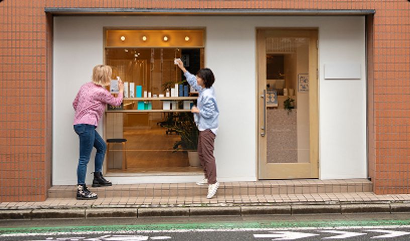 Outside view of retails store with two people window shopping