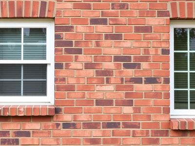 Brick exterior wall with windows on a home