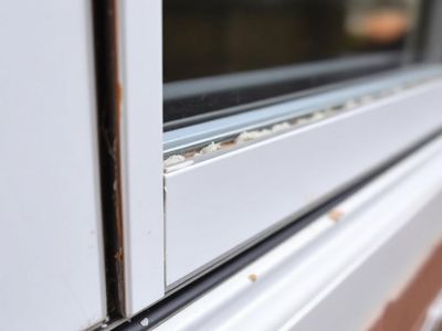 Caulking bead around an exterior window frame