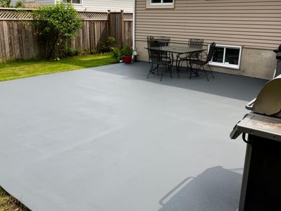 Backyard concrete patio with a clean painted finish